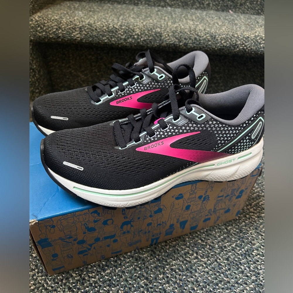 Brooks Womens Running Shoes. Mostly Black Mesh With The Colors Pink And Blue.